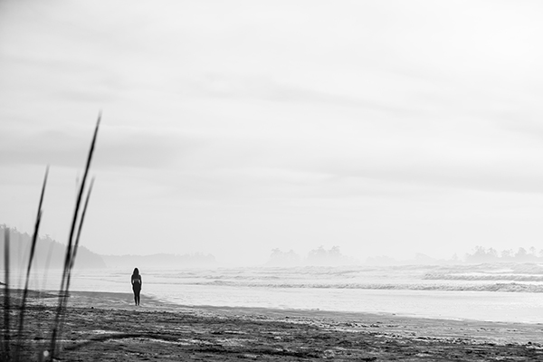 Laura walking on the beach with sky and ocean surrounding the landscape